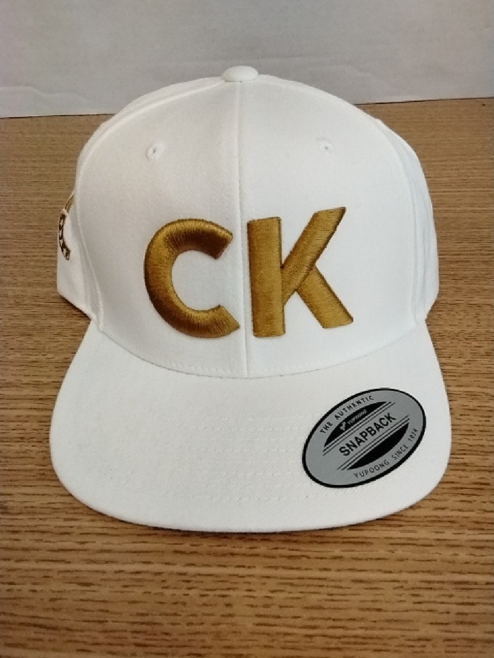 TPUSA Charlie Kirk White Snapback Hat with Gold 'CK' Embroidery